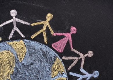 Chalk illustration of stick figures holding hands around earth